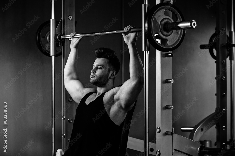 bodybuilder guy in gym with heavy weights monochrome bodybuilder guy in gym with heavy weights monochrome