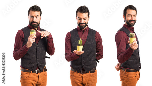 Man wearing waistcoat holding a cactus