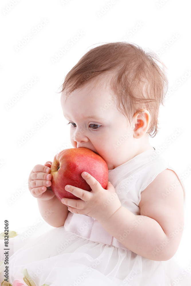 The girl is one year in dress sitting on a background. The girl is one year in dress sitting on a background.