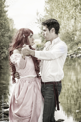 Fairy Tale Couple by a River Looking Dreamy at Each Other © theartofphoto