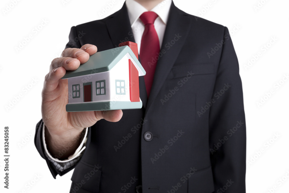 Businessman with house miniature in hand isolated on white Businessman with house miniature in hand isolated on white