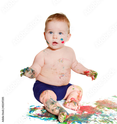 portrait of baby playing with bright colors, getting messy 