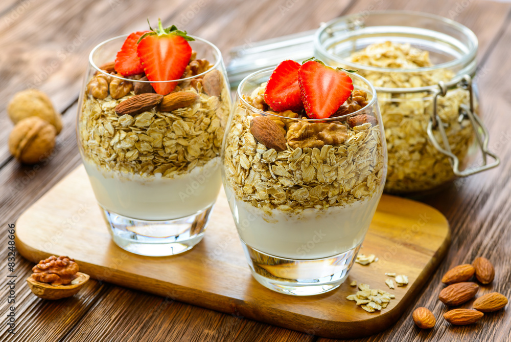 Fresh healthy breakfast of granola, yogurt, nuts and Fresh healthy breakfast of granola, yogurt, nuts and