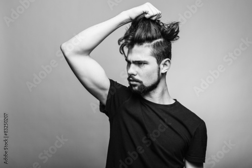 Young man in black T-shirt with fashionable hairstyle