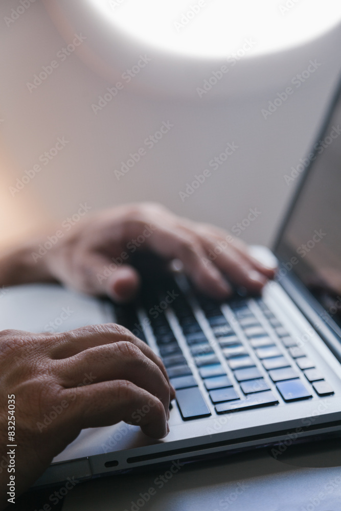 Man Using a Laptop During a Flight Man Using a Laptop During a Flight