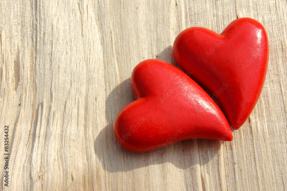 Two heart and wooden background