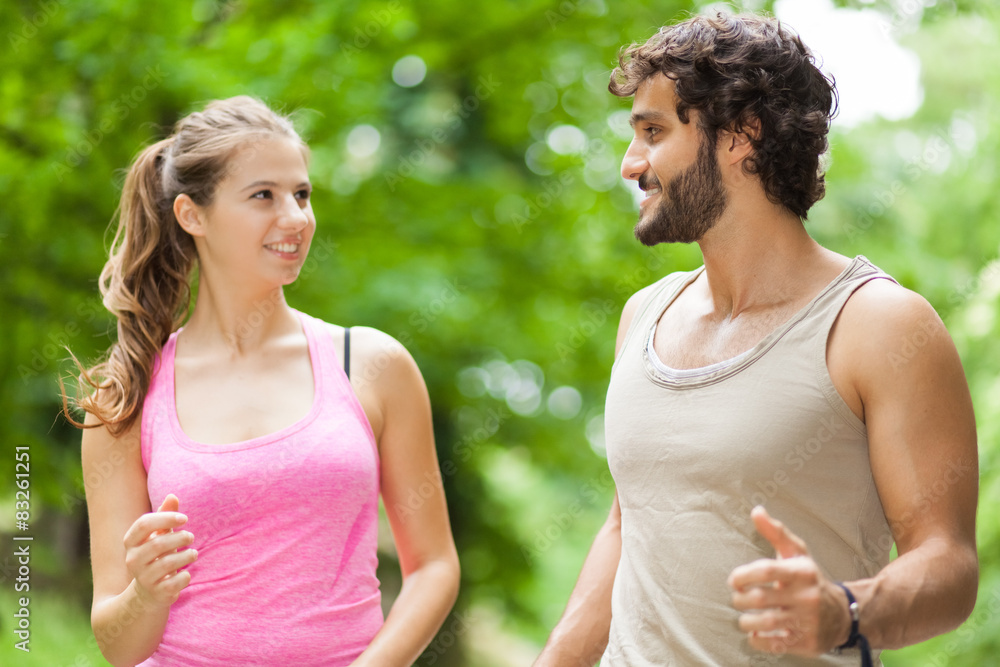 Portrait of cheerful Caucasian couple running outdoors Portrait of cheerful Caucasian couple running outdoors