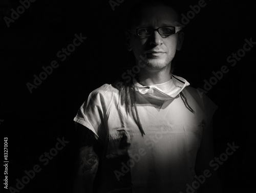 Portrait of male nurse ICU with tattoo and dreadlocks.