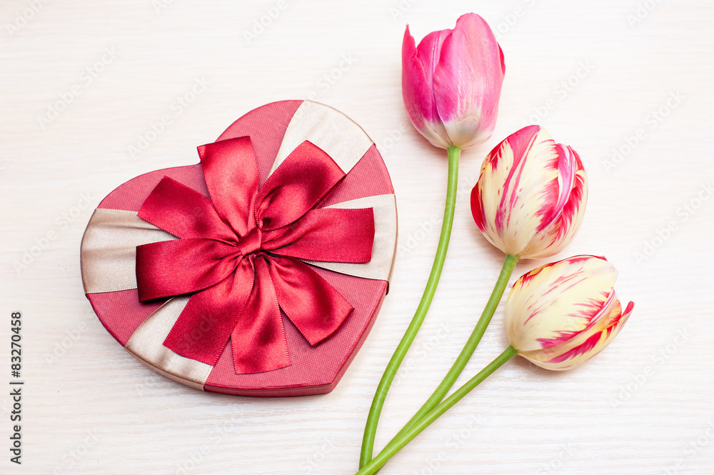 Tulips and gift box on a white background Tulips and gift box on a white background