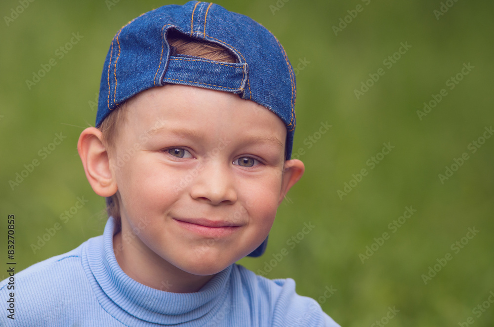 Little boy in denim cap looks directly. Little boy in denim cap looks directly.