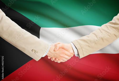 Businessmen handshake with flag on background - Kuwait