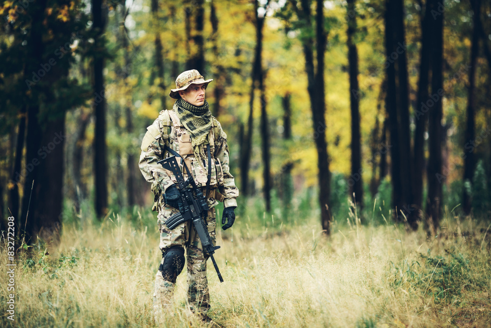 soldier with rifle in the forest