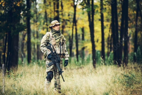 soldier with rifle in the forest