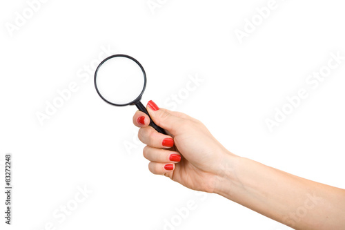 Woman's hand holding a magnifying glass