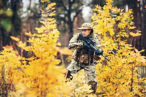 soldier with rifle in the forest