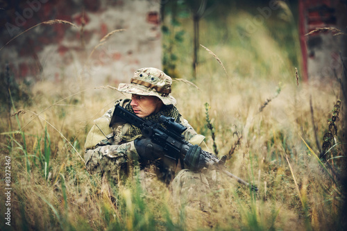 soldier with rifle in the forest