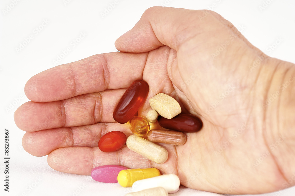 Vitamin Supplements in palm of hand Vitamin Supplements in palm of hand