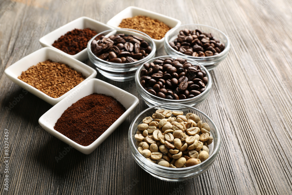 Coffee beans in saucers on wooden background Coffee beans in saucers on wooden background