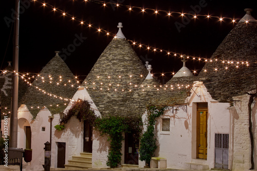 Alberobello trullo at night decorated with hundreds lights