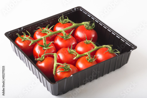 Aerial view fresh red tomatoes in black plastic tray