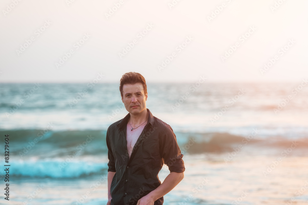 Casual sexy and serious man standing at beach. Casual sexy and serious man standing at beach.