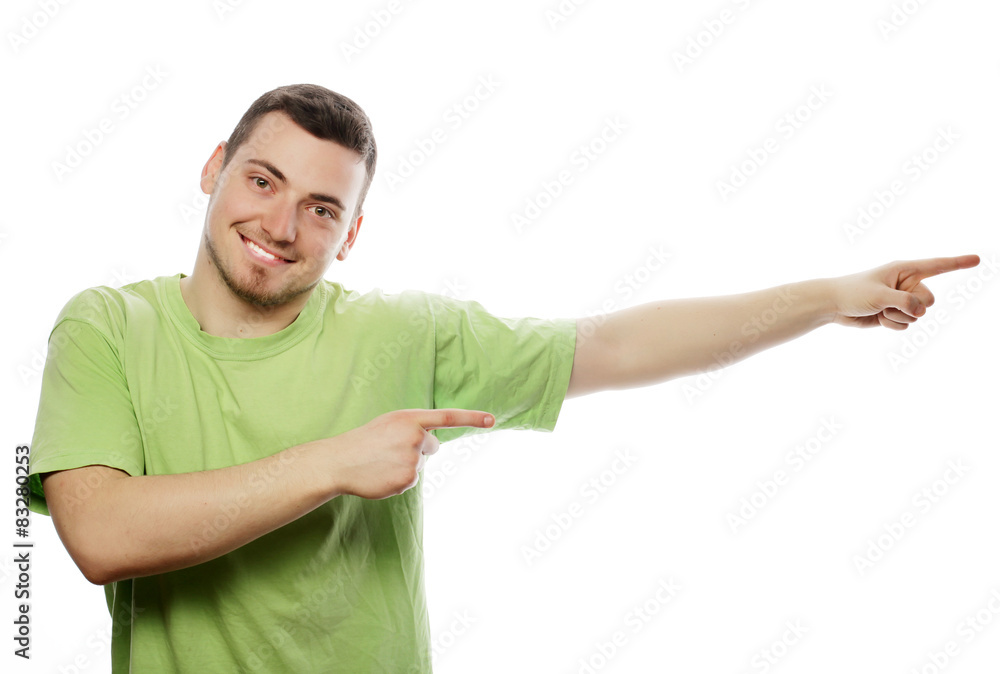 Young smiling happy man shows something Young smiling happy man shows something