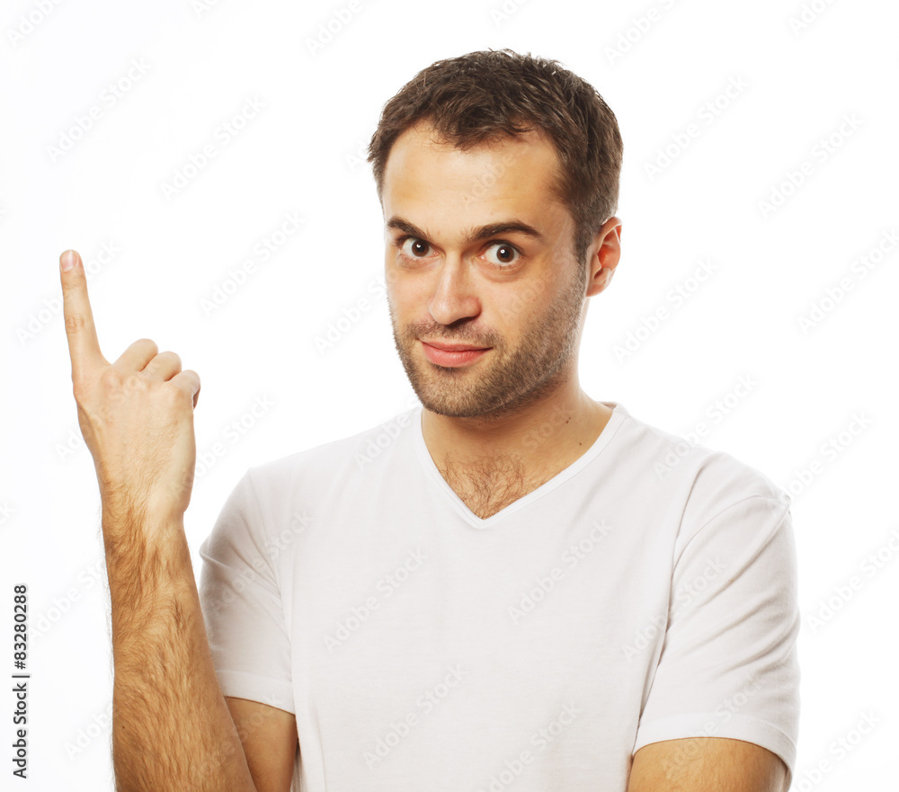 Young smiling happy man shows something Young smiling happy man shows something