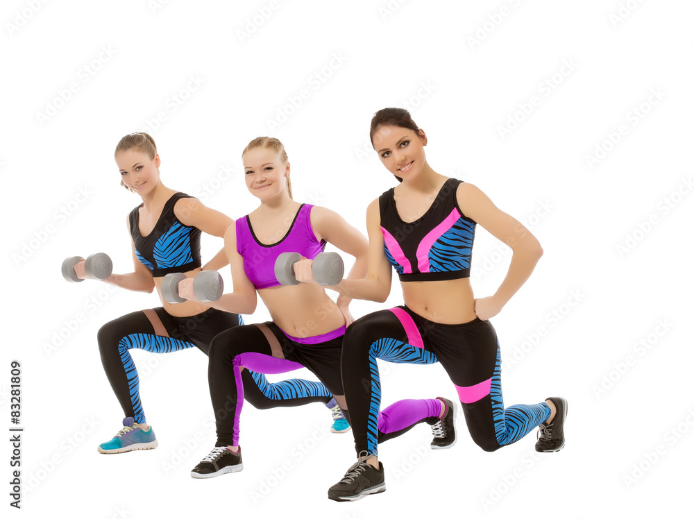 Training with dumbbells. Shot of cute girls posing Training with dumbbells. Shot of cute girls posing