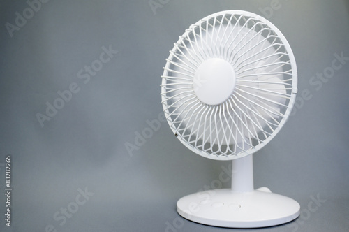 Rotating electric fan on gray background