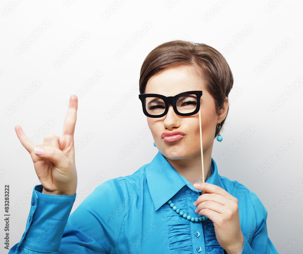 Playful young women holding a party glasses. 