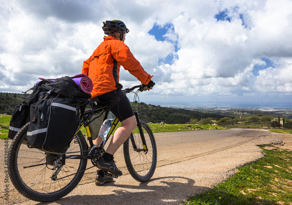 Fototapeta premium Bicyclist rides on the road