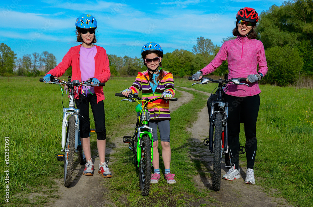 Mother and kids on bikes cycling outdoors, family sport
Mother and kids on bikes cycling outdoors, family sport