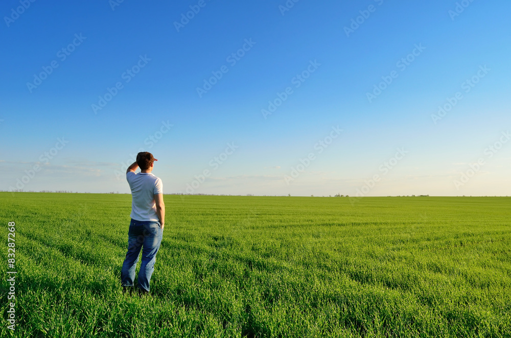 Man looks into the distance on the field