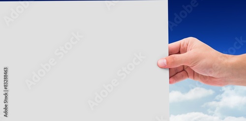 Composite image of hand showing card