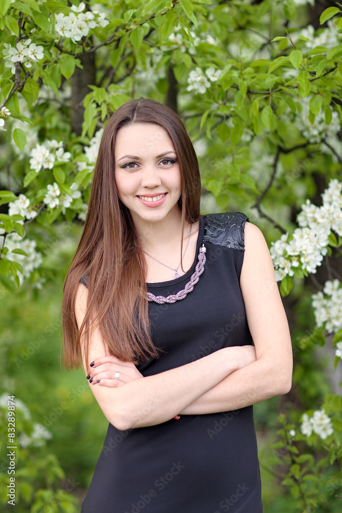 Girl in black standing on a blooming lilac backgroud Girl in black standing on a blooming lilac backgroud