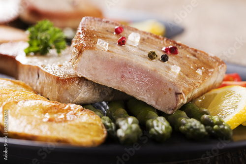 Grilled tuna steak served on asparagus with roasted zmieniakami