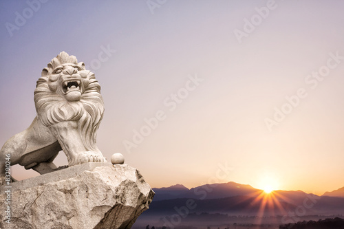 lion statue with landscape at sunrise