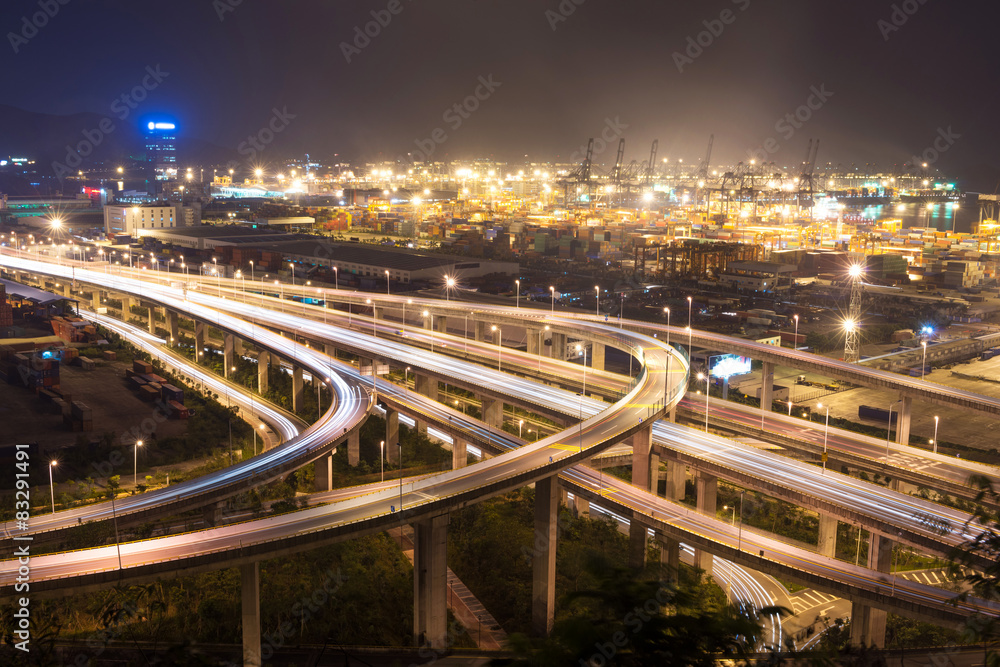 Fototapeta premium Illuminated and elevated expressway and cityscape at night