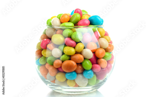 Colorful candies in glass bowl isolated on white