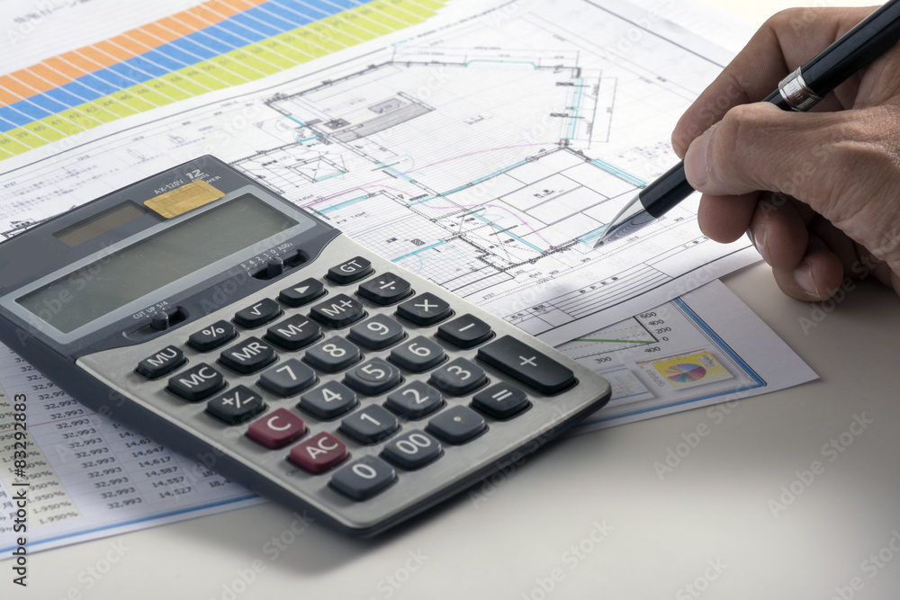 Businessman hand holding pen on blueprint Businessman hand holding pen on blueprint