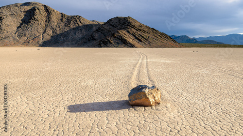 Moving stones in desert in the Racetrack playa, Death Valley National Park, California photo