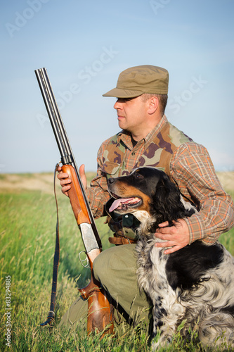 Hunter with a dog on the field