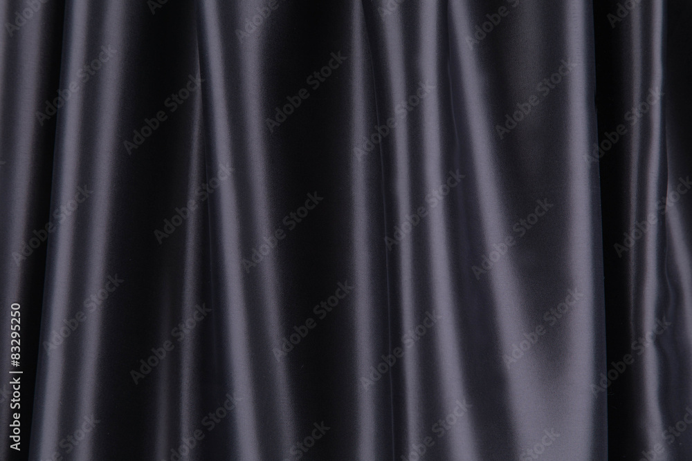 Soft folds of black silk cloth.