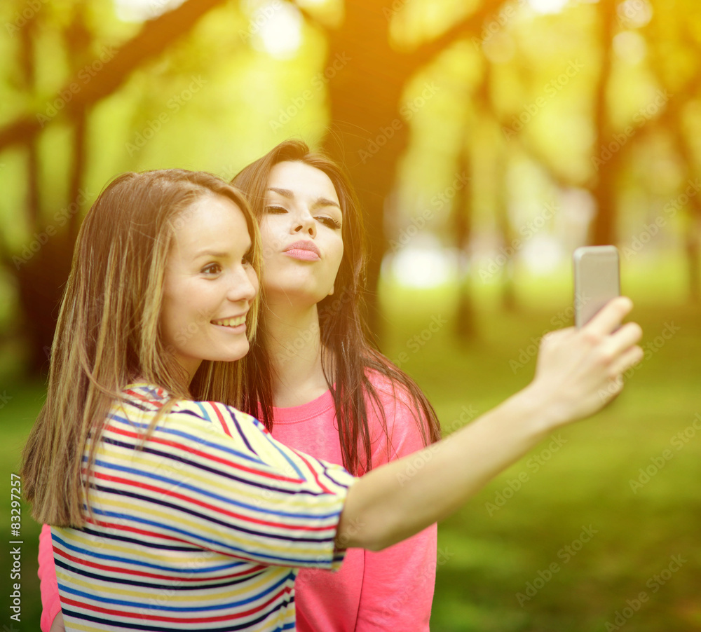 Friends making selfie on beautiful summer day in park Friends making selfie on beautiful summer day in park