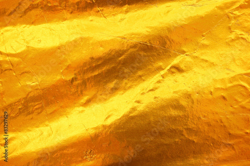 Shiny yellow leaf dark gold foil texture background