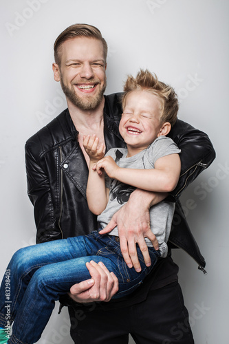 Young father and son laughing together. Fathers day 