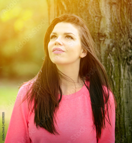 Portrait close up of young beautiful smiling woman in nature © irishmaster