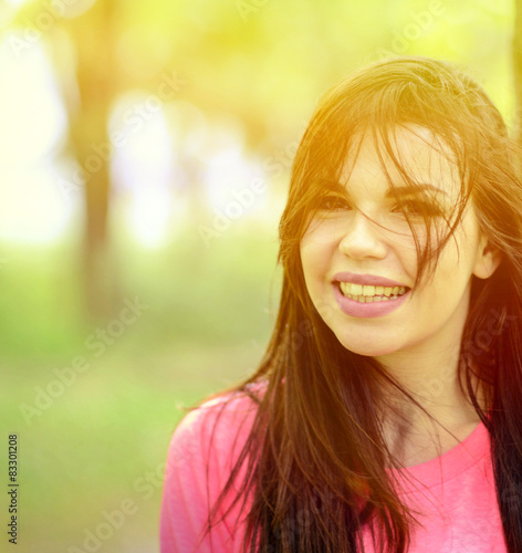 Portrait close up of young beautiful smiling woman in nature