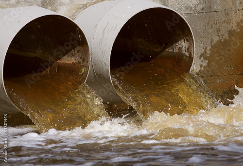 Photography Toxic water running from a sewer to the river