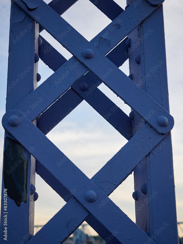 Detail of painted riveted bridge against blue sky. Detail of painted riveted bridge against blue sky.